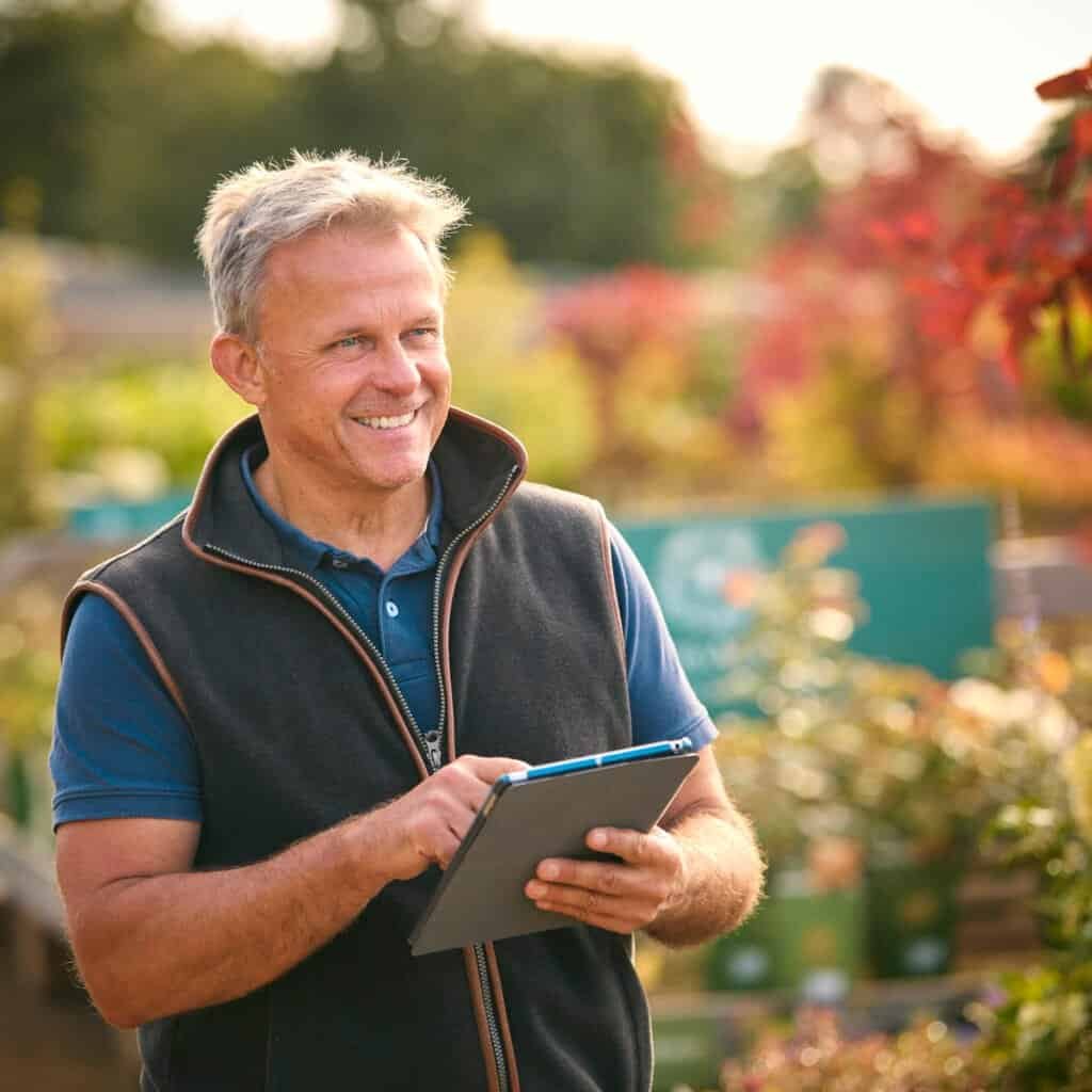 Detailed image of a man enjoying a professional landscape consultation in a lush garden.