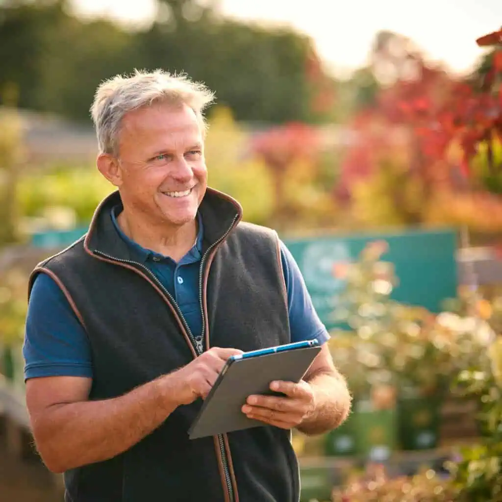 Detailed image of a man enjoying a professional landscape consultation in a lush garden.